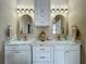 Bathroom with double sinks, granite counters, and a neutral color palette at 3008 Sutton Woods Dr, Plant City, FL 33566