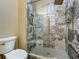 Bathroom featuring a modern glass shower with a unique design and a toilet for convenience at 3008 Sutton Woods Dr, Plant City, FL 33566