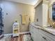 Bathroom featuring double sinks, granite countertops, and a glass shower for a luxurious feel at 3008 Sutton Woods Dr, Plant City, FL 33566
