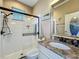 Modern bathroom boasts a tiled shower with sleek fixtures, granite counters, stylish mirror, and a comfort-height toilet at 3008 Sutton Woods Dr, Plant City, FL 33566