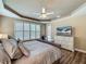 Spacious bedroom with a king bed, large windows, and a ceiling fan at 3008 Sutton Woods Dr, Plant City, FL 33566