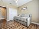 Cozy bedroom with a daybed, wood floors, closet and a ceiling fan, offering a relaxing space at 3008 Sutton Woods Dr, Plant City, FL 33566