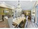 Open concept dining room with modern decor, chandelier, and view into the living room at 3008 Sutton Woods Dr, Plant City, FL 33566