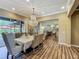 Elegant dining room with a chandelier, hardwood floors, and seating for six people at 3008 Sutton Woods Dr, Plant City, FL 33566