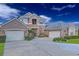 Charming two-story home with a stone facade, multi-car garage, and well-maintained landscaping under a bright blue sky at 3008 Sutton Woods Dr, Plant City, FL 33566