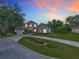 Stunning two-story home with stone accents, manicured lawn, and colorful sunset backdrop at 3008 Sutton Woods Dr, Plant City, FL 33566