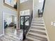 Grand foyer featuring a staircase and an elegant entryway with lots of natural light at 3008 Sutton Woods Dr, Plant City, FL 33566