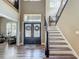 Inviting foyer featuring beautiful wood floors, ornate glass doors, and a staircase at 3008 Sutton Woods Dr, Plant City, FL 33566