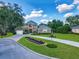 Beautiful two-story home featuring a lush lawn, curved driveway, and a three-car garage at 3008 Sutton Woods Dr, Plant City, FL 33566