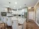 Modern kitchen featuring an island, stainless steel appliances, and stylish bar stools at 3008 Sutton Woods Dr, Plant City, FL 33566