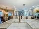 Spacious kitchen with granite counters overlooks the living area, fostering an open, inclusive atmosphere at 3008 Sutton Woods Dr, Plant City, FL 33566