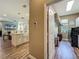 View of a modern kitchen island with sink and an open doorway to the laundry room with appliances and storage at 3008 Sutton Woods Dr, Plant City, FL 33566