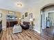 Comfortable living room with elegant furniture, entertainment center, and wood-look floors at 3008 Sutton Woods Dr, Plant City, FL 33566