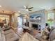 The living room has a stone accent wall, backyard views, and a contemporary ceiling fan at 3008 Sutton Woods Dr, Plant City, FL 33566