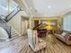 Elegant living room featuring a piano, staircase, modern decor, and wood flooring at 3008 Sutton Woods Dr, Plant City, FL 33566