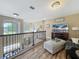 Upstairs loft area with railing, chandelier, and living space at 3008 Sutton Woods Dr, Plant City, FL 33566