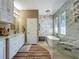 Spa-like main bathroom with soaking tub, marble accents, and modern vanity at 3008 Sutton Woods Dr, Plant City, FL 33566