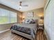 Bedroom featuring a comfortable bed with stylish bedding, complemented by a ceiling fan and natural light at 3008 Sutton Woods Dr, Plant City, FL 33566