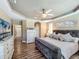 Inviting main bedroom featuring wood floors, tray ceilings, and plantation shutters at 3008 Sutton Woods Dr, Plant City, FL 33566