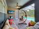 Outdoor patio with a ceiling fan, television, hammock, and cushioned seating at 3008 Sutton Woods Dr, Plant City, FL 33566