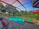 A sparkling, screened-in pool and hot tub combo provide the perfect backyard oasis for relaxation and fun at 3008 Sutton Woods Dr, Plant City, FL 33566