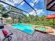 A sparkling, screened-in pool and hot tub combo provide the perfect backyard oasis for relaxation and fun at 3008 Sutton Woods Dr, Plant City, FL 33566
