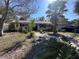 Charming home featuring a well-manicured front yard with brick pathway and mature landscaping at 560 7Th S St, Safety Harbor, FL 34695