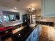 Kitchen featuring white cabinets, wood flooring, black appliances, and view to another room at 560 7Th S St, Safety Harbor, FL 34695