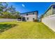 Spacious backyard with a well-maintained lawn, privacy fence and screened patio at 5703 New Paris Way, Ellenton, FL 34222