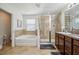 Bathroom with granite countertops, dual sinks, shower, and soaking tub at 5703 New Paris Way, Ellenton, FL 34222