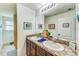 Bathroom with dual sinks, granite countertops, and decorative fish art at 5703 New Paris Way, Ellenton, FL 34222