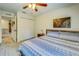 Relaxing bedroom with blue accents and a queen size bed near the closet and entry at 5703 New Paris Way, Ellenton, FL 34222