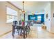 Cozy dining room with natural light, transitioning into a comfortable living area with stylish blue accent wall at 5703 New Paris Way, Ellenton, FL 34222
