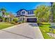Beautiful two-story home featuring manicured landscaping and a wide driveway at 5703 New Paris Way, Ellenton, FL 34222