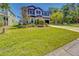 Beautiful two-story home featuring manicured landscaping and a wide green lawn at 5703 New Paris Way, Ellenton, FL 34222