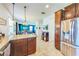Kitchen features stainless steel appliances, granite countertops, and a view into the living and dining areas at 5703 New Paris Way, Ellenton, FL 34222