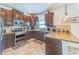 Well-equipped kitchen with stainless steel appliances, granite countertops and ample cabinet space at 5703 New Paris Way, Ellenton, FL 34222