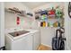 Well-organized laundry room with storage shelves and a modern washer and dryer at 5703 New Paris Way, Ellenton, FL 34222