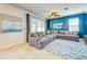 Cozy living room features a large sectional sofa, an area rug, and sliding door access to the outdoors at 5703 New Paris Way, Ellenton, FL 34222