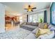 Open-concept living room and kitchen layout, with a large sectional sofa and a view of the backyard at 5703 New Paris Way, Ellenton, FL 34222