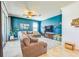 Spacious living room with a large gray sectional sofa, modern TV setup, and sliding glass doors to the exterior at 5703 New Paris Way, Ellenton, FL 34222