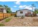 Spacious backyard with a partial fence, landscaping, and a view of the back of the home at 6220 Pershing Ne St, St Petersburg, FL 33702