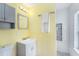 Cozy bathroom featuring a tiled shower, vanity, and bright yellow walls at 6801 16Th N St, St Petersburg, FL 33702