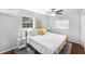 Bright bedroom with a large window, ceiling fan, and comfortable furnishings at 6801 16Th N St, St Petersburg, FL 33702