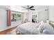 Bright bedroom featuring a gold bed frame, ceiling fan, and large window at 6801 16Th N St, St Petersburg, FL 33702