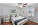 Cozy bedroom showcasing a gold bedframe, hardwood floors, and two windows for an abundance of natural light at 6801 16Th N St, St Petersburg, FL 33702