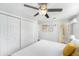 Comfortable bedroom featuring a ceiling fan, a large closet, and white walls at 6801 16Th N St, St Petersburg, FL 33702