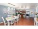 Bright dining room featuring a white table set, modern pendant lighting, and adjacent kitchen at 6801 16Th N St, St Petersburg, FL 33702