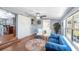 Inviting living area featuring a blue sofa, ceiling fan, and wood flooring at 6801 16Th N St, St Petersburg, FL 33702
