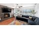 Cozy living room boasts a brick fireplace, large windows, and comfortable sectional seating at 6801 16Th N St, St Petersburg, FL 33702
